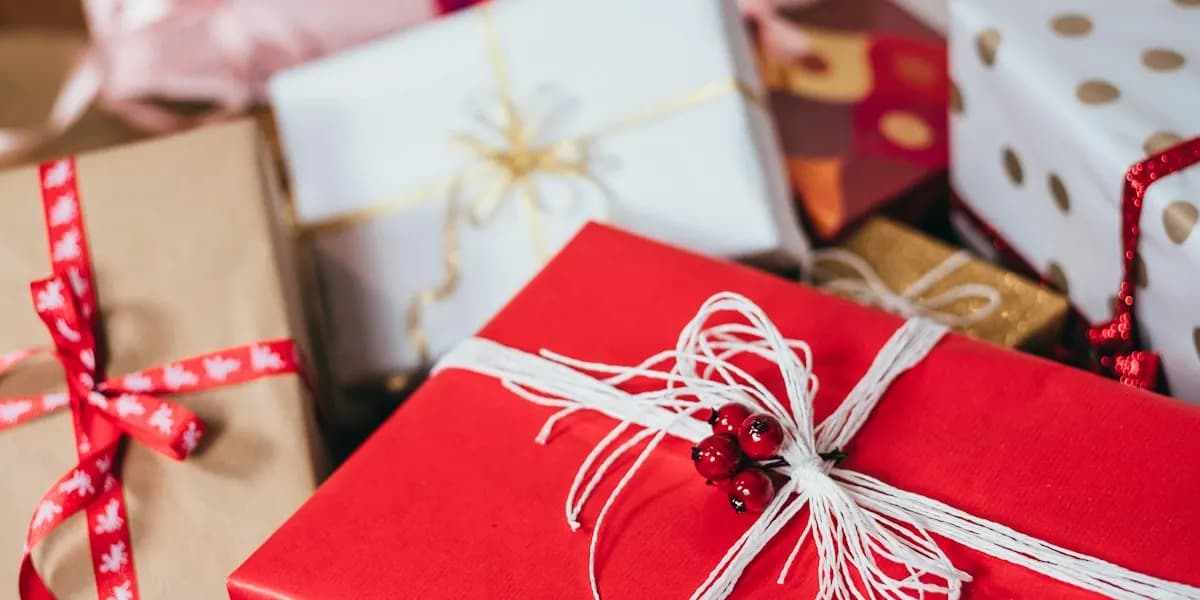 Wrapped Christmas presents with red ribbons and twine