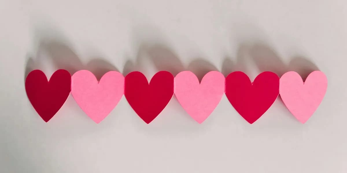 A row of red and pink paper hearts